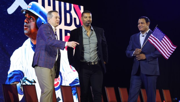 Cubs Chairman Tom Ricketts, left, welcomes former players Derrek Lee, center, and Sammy Sosa to the stage during the opening ceremony of the Cubs Convention on Jan. 17, 2025, at the Sheraton Grand Chicago Riverwalk. (John J. Kim/Chicago Tribune)