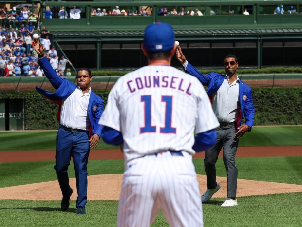 Chicago Cubs Hall of Famers Sammy Sosa, left, and Derrek Lee throw in the first pitch at Wrigley Fieldon Sept. 7, 2025, in Chicago. (Stacey Wescott/Chicago Tribune)