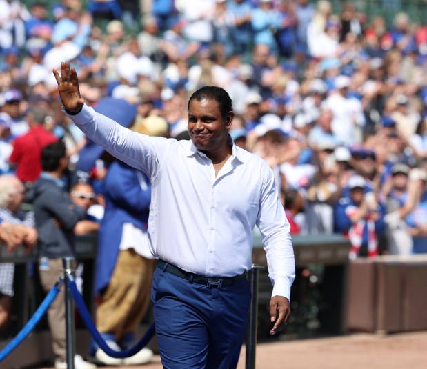 Chicago Cubs Hall of Famer Sammy Sosa is welcomed onto the field to throw out the first pitch at Wrigley Field on Sept. 7, 2025, in Chicago. (Stacey Wescott/Chicago Tribune)