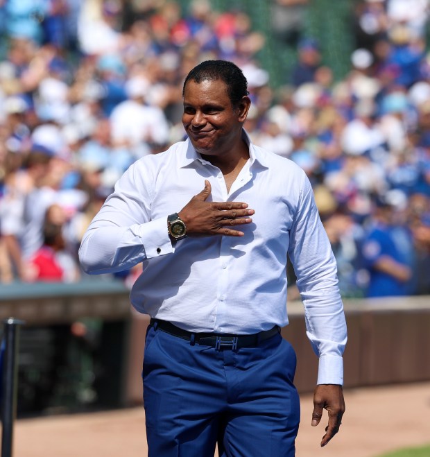 Chicago Cubs Hall of Famer Sammy Sosa is welcomed onto the field to throw out the first pitch at Wrigley Field on Sept. 7, 2025, in Chicago. (Stacey Wescott/Chicago Tribune)