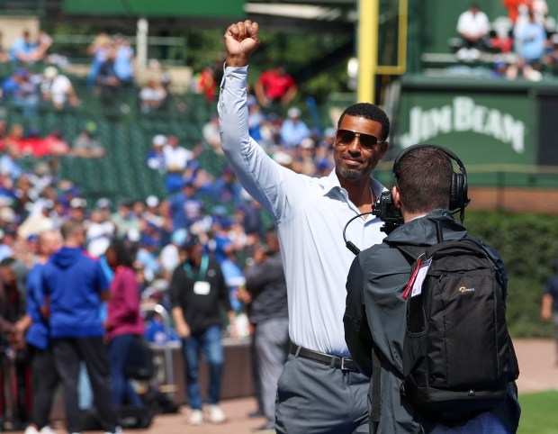Chicago Cubs Hall of Famer Derrek Lee is welcomed by fans before throwing out the first pitch at Wrigley Field on Sept. 7, 2025, in Chicago. (Stacey Wescott/Chicago Tribune)