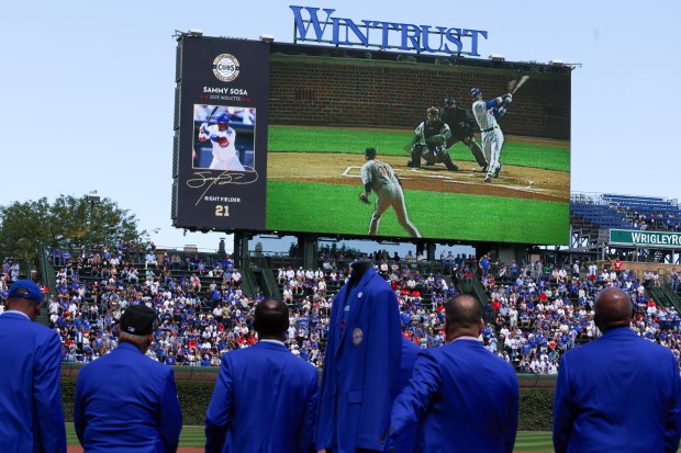 Chicago Cubs Hall of Famers watch a video highlighting Sammy Sosa at Wrigley Field on Sept. 7, 2025, in Chicago. (Stacey Wescott/Chicago Tribune)