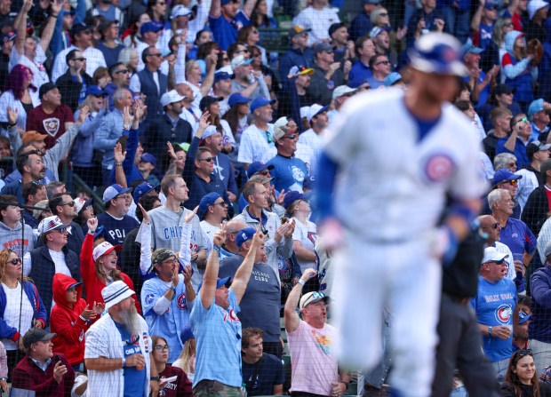 Fans raise their arms as they watch Chicago Cubs catcher Carson Kelly (15) hit his second home run of the game against the Washinton Nationals at Wrigley Field on Sept. 7, 2025, in Chicago. (Stacey Wescott/Chicago Tribune)