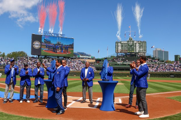 Chicago Cubs Hall of Famers Sammy Sosa and Derrek Lee receive their blue blazers while surrounded by fellow Cubs' Hall of Famer at Wrigley Field on Sept. 7, 2025, in Chicago. (Stacey Wescott/Chicago Tribune)