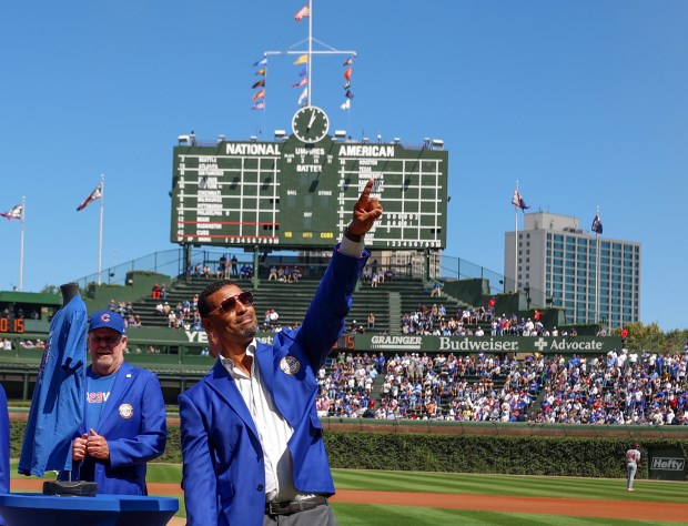 Chicago Cubs Hall of Famer Derrek Lee points to the crowd after receiving his blue jacket at Wrigley Field on Sept. 7, 2025, in Chicago. (Stacey Wescott/Chicago Tribune)