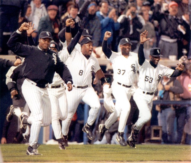 Frank Thomas, left, and Bo Jackson (8) lead the team charge from the dugout as the Chicago White Sox clinched their first American League West title since 1983 with a 4-2 victory on Sept. 27, 1993 over the Seattle Mariners before a capacity crowd at Comiskey Park. (Michael Fryer/Chicago Tribune)