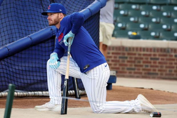 Chicago Cub Ian Happ watches teammates take batting practice at Wrigley Field in Chicago on Monday, Sept. 29, 2025, as the team gets ready to face the Padres in a wild-card playoff series starting on Tuesday. (Terrence Antonio James/Chicago Tribune)