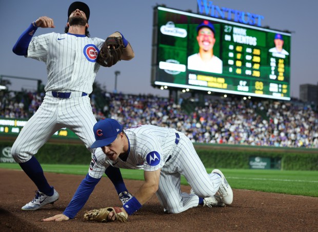 Cubs shortstop Dansby Swanson looks up as third baseman Matt Shaw trips while chasing a pop up from Mets designated hitter Mark Vientos in the first inning at Wrigley Field on Sept. 25, 2025, in Chicago. (John J. Kim/Chicago Tribune)