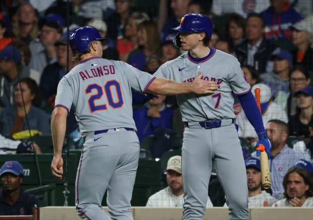 Mets first baseman Pete Alonso celebrates with third baseman Brett Baty after scoring in the first inning against the Cubs at Wrigley Field on Sept. 25, 2025, in Chicago. (John J. Kim/Chicago Tribune)