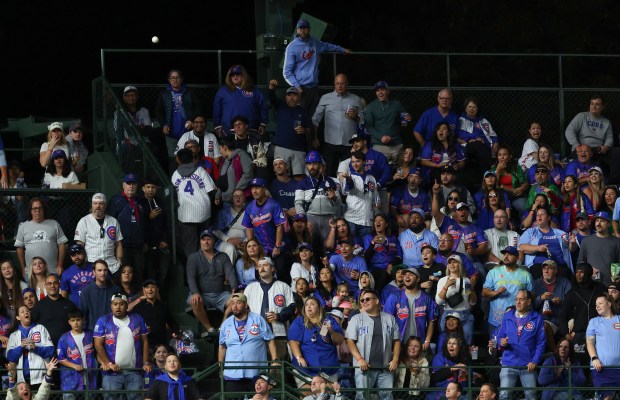 Fans watch a ball hit by Mets third baseman Brett Baty fly for a three-run home run in the fourth inning against the Cubs at Wrigley Field on Sept. 25, 2025, in Chicago. (John J. Kim/Chicago Tribune)