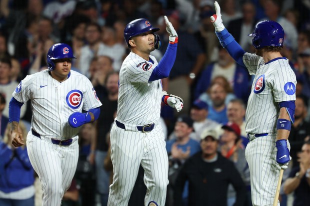 Cubs right fielder Seiya Suzuki, center, is congratulated after hitting a three-run home run in the sixth inning against the Mets at Wrigley Field on Sept. 25, 2025, in Chicago. (John J. Kim/Chicago Tribune)