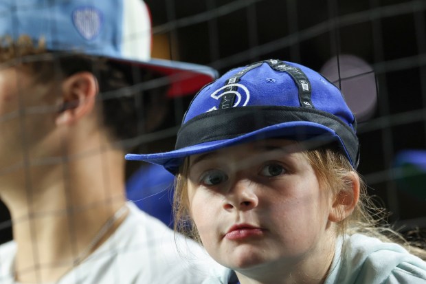 A young Cubs fan wears her rally cap in the ninth inning against the Mets at Wrigley Field on Sept. 25, 2025, in Chicago. (John J. Kim/Chicago Tribune)