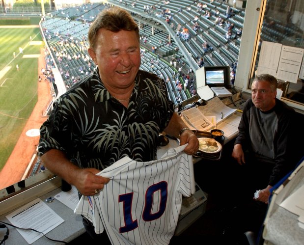 Chicago Cubs broadcaster Ron Santo holds his No. 10 jersey in the radio booth on Sept. 15, 2003, at Wrigley Field where he provides commentary for WGN radio. (Nuccio DiNuzzo/Chicago Tribune)