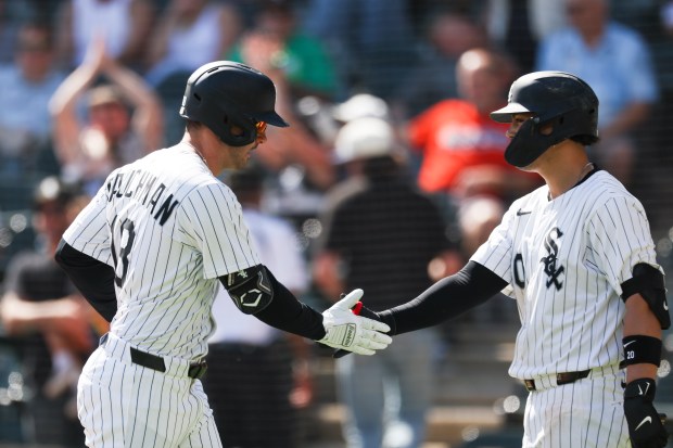 Chicago White Sox outfielder Mike Tauchman (18) gets a high-five from third base Miguel Vargas (20) after hitting a home run during the fourth inning against the Baltimore Orioles at Rate Field on Wednesday, Sept. 17, 2025. (Eileen T. Meslar/Chicago Tribune)