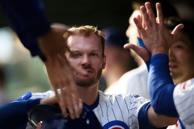 Chicago Cubs outfielder Ian Happ (8) celebrates in the dugout after scoring off a RBI single from Chicago Cubs outfielder Willi Castro (1) during the second inning against the Atlanta Braves at Wrigley Field Wednesday Sept. 3, 2025, in Chicago. (Armando L. Sanchez/Chicago Tribune)