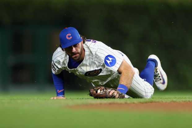 Chicago Cubs shortstop Dansby Swanson (7) gets off the ground after making a catch off Atlanta Braves catcher Drake Baldwin (30) during the fourth inning at Wrigley Field Wednesday Sept. 3, 2025, in Chicago. (Armando L. Sanchez/Chicago Tribune)