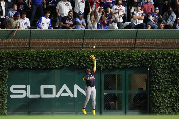 Atlanta Braves outfielder Ronald Acuña Jr. (13) catches a ball from Chicago Cubs first base Carlos Santana (41). during the fourth inning at Wrigley Field Wednesday Sept. 3, 2025, in Chicago. (Armando L. Sanchez/Chicago Tribune)