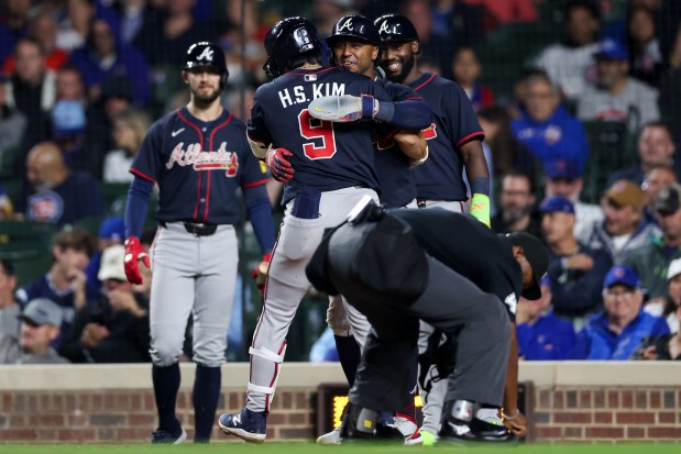 Atlanta Braves shortstop Ha-Seong Kim (9) celebrates with Atlanta Braves second base Ozzie Albies (1) after Kim hit a three-run homer during the seventh inning against the Chicago Cubs at Wrigley Field Wednesday Sept. 3, 2025, in Chicago. (Armando L. Sanchez/Chicago Tribune)
