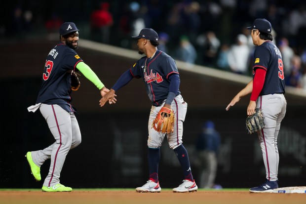 Atlanta Braves outfielder Michael Harris II (23), Atlanta Braves second base Ozzie Albies (1), and Atlanta Braves shortstop Ha-Seong Kim (9) celebrate after the Braves defeated the Chicago Cubs, 5-1, at Wrigley Field Wednesday Sept. 3, 2025, in Chicago. (Armando L. Sanchez/Chicago Tribune)