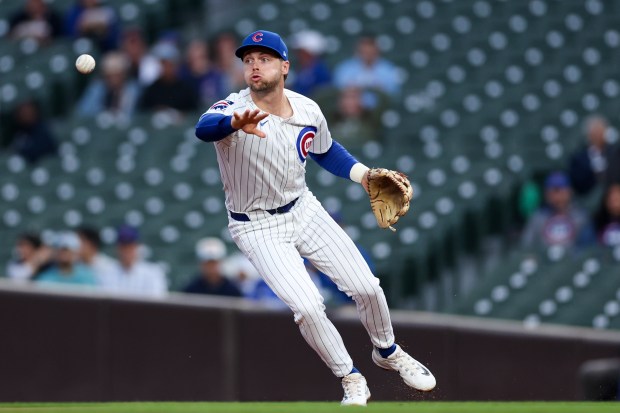 Chicago Cubs second base Nico Hoerner (2) tosses the ball to Chicago Cubs shortstop Dansby Swanson (7) to tag out Atlanta Braves first base Matt Olson (28) at second during the first inning at Wrigley Field Wednesday Sept. 3, 2025, in Chicago. (Armando L. Sanchez/Chicago Tribune)