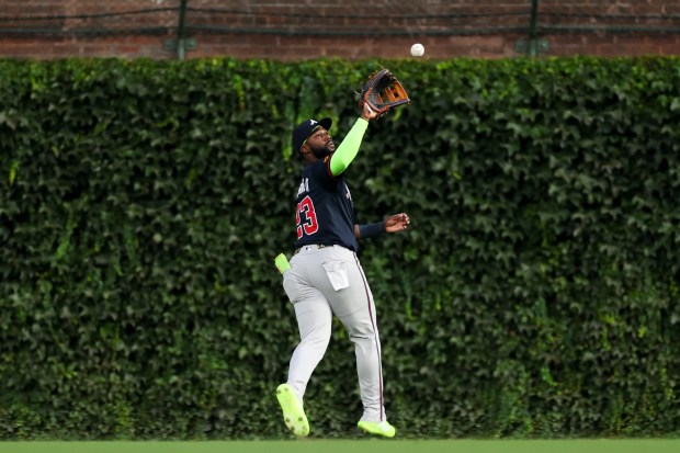 Atlanta Braves outfielder Michael Harris II (23) catches a ball from Chicago Cubs second base Nico Hoerner (2) during the first inning at Wrigley Field Wednesday Sept. 3, 2025, in Chicago. (Armando L. Sanchez/Chicago Tribune)