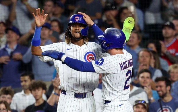 Chicago Cubs players Kevin Alcántara (left) and Nico Hoerner (right) celebrate at home plate after the two scored on a 3-run home run by right fielder Kyle Tucker in the third inning of a game against the Atlanta Braves at Wrigley Field in Chicago on Sept. 2, 2025. (Chris Sweda/Chicago Tribune)