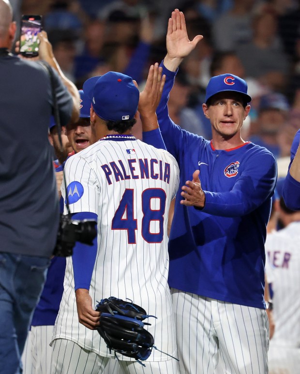 Chicago Cubs relief pitcher Daniel Palencia (48) and manager Craig Counsell celebrate after a Cubs victory over the Atlanta Braves at Wrigley Field in Chicago on Sept. 2, 2025. (Chris Sweda/Chicago Tribune)