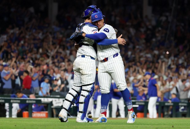 Chicago Cubs catcher Carson Kelly and relief pitcher Daniel Palencia (right) celebrate after a victory over the Atlanta Braves at Wrigley Field in Chicago on Sept. 2, 2025. (Chris Sweda/Chicago Tribune)
