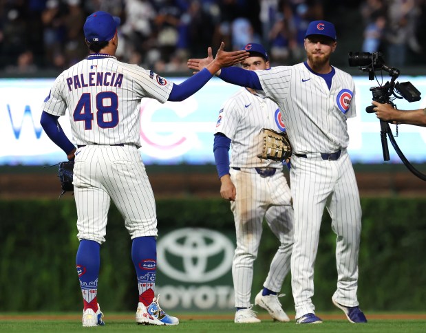 Chicago Cubs relief pitcher Daniel Palencia (48) and first baseman Michael Busch (29) celebrate after a victory over the Atlanta Braves at Wrigley Field in Chicago on Sept. 2, 2025. (Chris Sweda/Chicago Tribune)