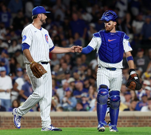 Chicago Cubs relief pitcher Drew Pomeranz and catcher Carson Kelly (right) congratulated one another after shutting down the Atlanta Braves in the seventh inning of a game at Wrigley Field in Chicago on Sept. 2, 2025. (Chris Sweda/Chicago Tribune)