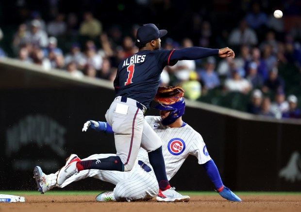 Atlanta Braves second baseman Ozzie Albies (1) throws to first base to complete a double play after forcing out Chicago Cubs designated hitter Seiya Suzuki at second base in the fifth inning of a game at Wrigley Field in Chicago on Sept. 2, 2025. (Chris Sweda/Chicago Tribune)