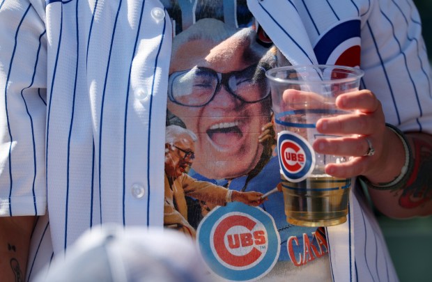 A Chicago Cubs fan wearing a shirt adorned with an image of Harry Caray waits for the start of a game between the Cubs and the St. Louis Cardinals at Wrigley Field in Chicago on Sept. 26, 2025. (Chris Sweda/Chicago Tribune)