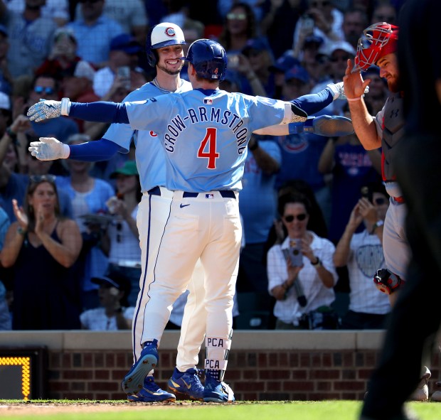 Chicago Cubs center fielder Pete Crow-Armstrong (4) is congratulated by teammate Kyle Tucker after Crow-Armstrong hit a 2-run home run in the fourth inning of a game against the St. Louis Cardinals at Wrigley Field in Chicago on Sept. 26, 2025. (Chris Sweda/Chicago Tribune)
