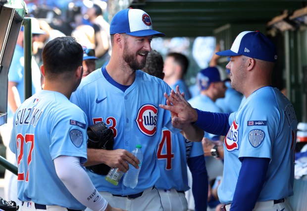 Chicago Cubs starting pitcher Colin Rea (center) and relief pitcher Caleb Thielbar (right) celebrate after the duo shut down the St. Louis Cardinals in the sixth inning of a game at Wrigley Field in Chicago on Sept. 26, 2025. (Chris Sweda/Chicago Tribune)