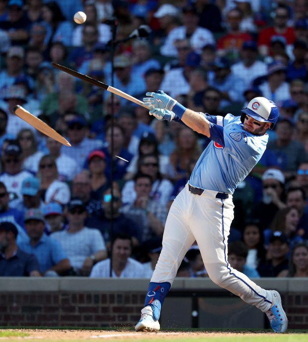 Chicago Cubs left fielder Ian Happ (8) breaks his bat as he drives in a run on an infield single in the seventh inning of a game against the St. Louis Cardinals at Wrigley Field in Chicago on Sept. 26, 2025. (Chris Sweda/Chicago Tribune)