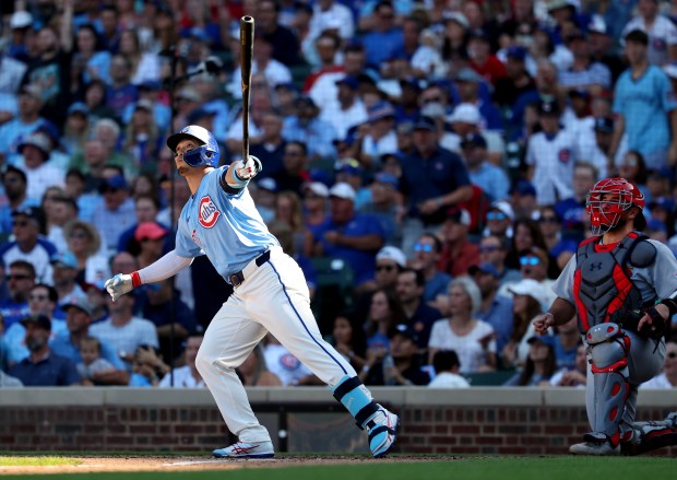 Chicago Cubs right fielder Seiya Suzuki watches the flight of his grand slam in the seventh inning of a game against the St. Louis Cardinals at Wrigley Field in Chicago on Sept. 26, 2025. (Chris Sweda/Chicago Tribune)