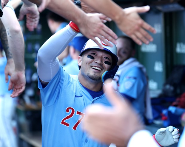 Chicago Cubs right fielder Seiya Suzuki is congratulated by his teammates in the dugout after hitting a grand slam in the seventh inning of a game against the St. Louis Cardinals at Wrigley Field in Chicago on Sept. 26, 2025. (Chris Sweda/Chicago Tribune)