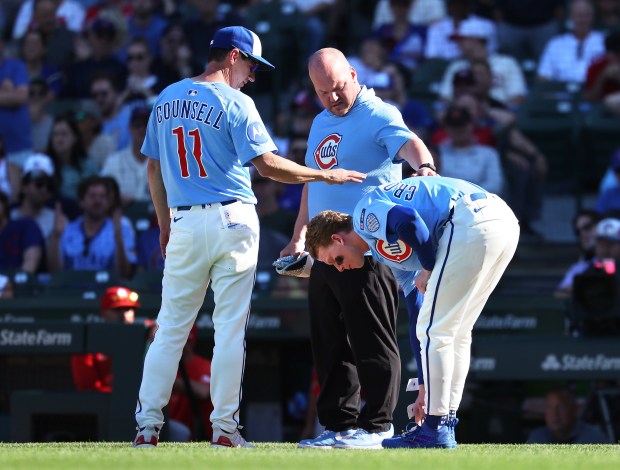 Chicago Cubs manager Craig Counsell (11) looks over Pete Crow-Armstrong after the Cubs center fielder was hit by a pitch in the seventh inning of a game against the St. Louis Cardinals at Wrigley Field in Chicago on Sept. 26, 2025. (Chris Sweda/Chicago Tribune)