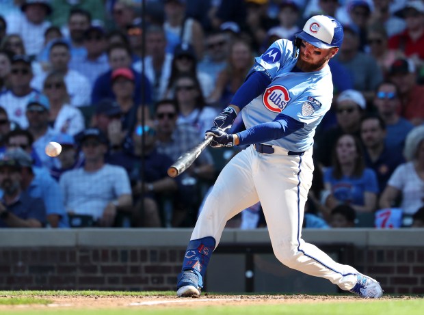 Chicago Cubs first baseman Michael Busch drives in a run on a double in the seventh inning of a game against the St. Louis Cardinals at Wrigley Field in Chicago on Sept. 26, 2025. (Chris Sweda/Chicago Tribune)