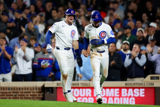 Chicago Cubs third base Matt Shaw (6) and Chicago Cubs second base Nico Hoerner (2) celebrate after scoring off a two RBI double from Chicago Cubs outfielder Ian Happ (8) during the second inning against the New York Mets at Wrigley Field Tuesday Sept. 23, 2025, in Chicago. (Armando L. Sanchez/Chicago Tribune)