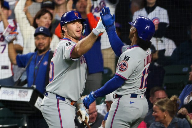 New York Mets first base Pete Alonso (20) celebrates with New York Mets shortstop Francisco Lindor (12) after Lindor hit a solo-homer during the first inning against the Chicago Cubs at Wrigley Field Tuesday Sept. 23, 2025, in Chicago. (Armando L. Sanchez/Chicago Tribune)