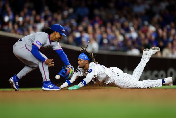 Chicago Cubs pinch-runner Kevin Alcántara (13) slides safely into second base past New York Mets shortstop Francisco Lindor (12) during the seventh inning at Wrigley Field Tuesday Sept. 23, 2025, in Chicago. (Armando L. Sanchez/Chicago Tribune)