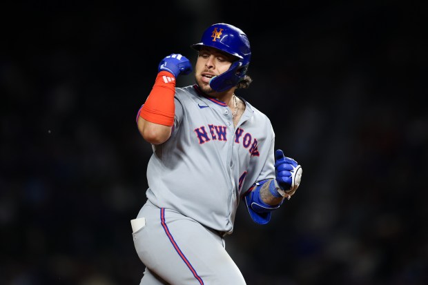 New York Mets catcher Francisco Alvarez (4) celebrates while running the bases after hitting a two-run homer during the eighth inning against the Chicago Cubs at Wrigley Field Tuesday Sept. 23, 2025, in Chicago. (Armando L. Sanchez/Chicago Tribune)