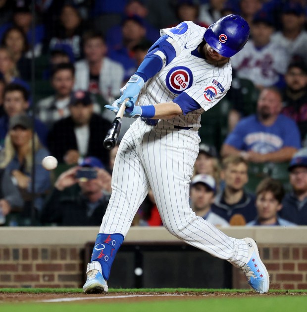 Chicago Cubs left fielder Ian Happ drives in two runs on a double in the third inning of a game against the New York Mets at Wrigley Field in Chicago on Sept. 24, 2025. (Chris Sweda/Chicago Tribune)