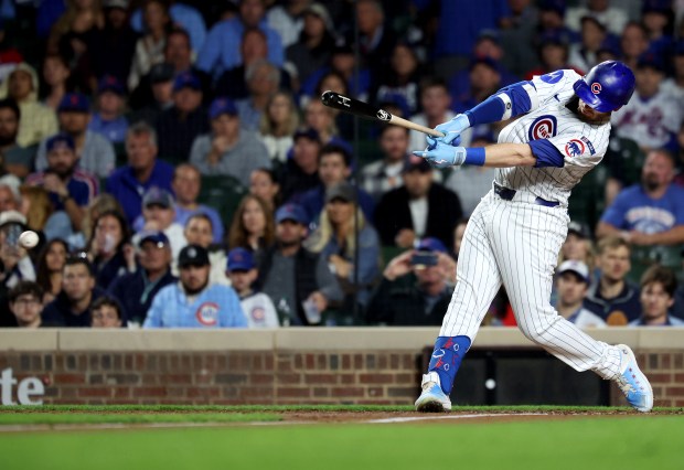 Chicago Cubs left fielder Ian Happ drives in two runs on a double in the third inning of a game against the New York Mets at Wrigley Field in Chicago on Sept. 24, 2025. (Chris Sweda/Chicago Tribune)