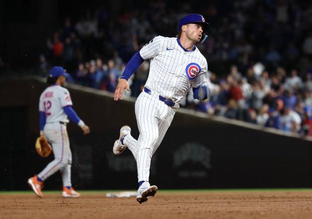Chicago Cubs second base Nico Hoerner (2) heads to third base on a two-run double by teammate Ian Happ in the third inning of a game against the New York Mets at Wrigley Field in Chicago on Sept. 24, 2025. (Chris Sweda/Chicago Tribune)