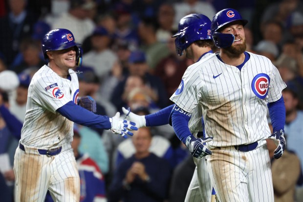 Chicago Cubs first baseman Michael Busch (right) and third baseman Matt Shaw (left) celebrate after Busch hit a two-run home run in the sixth inning of a game against the New York Mets at Wrigley Field in Chicago on Sept. 24, 2025. (Chris Sweda/Chicago Tribune)