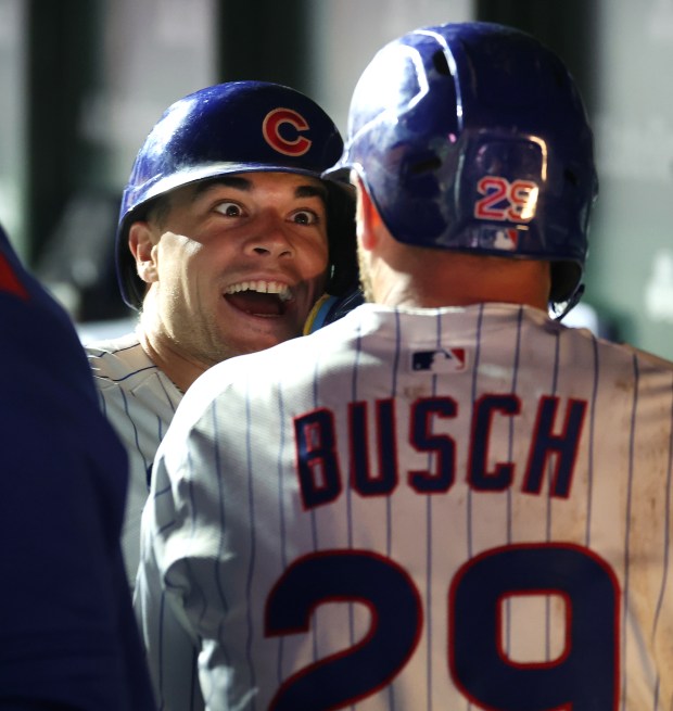 Chicago Cubs third baseman Matt Shaw (left) and first baseman Michael Busch (right) celebrate in the dugout after Busch hit a two-run home run in the sixth inning of a game against the New York Mets at Wrigley Field in Chicago on Sept. 24, 2025. (Chris Sweda/Chicago Tribune)