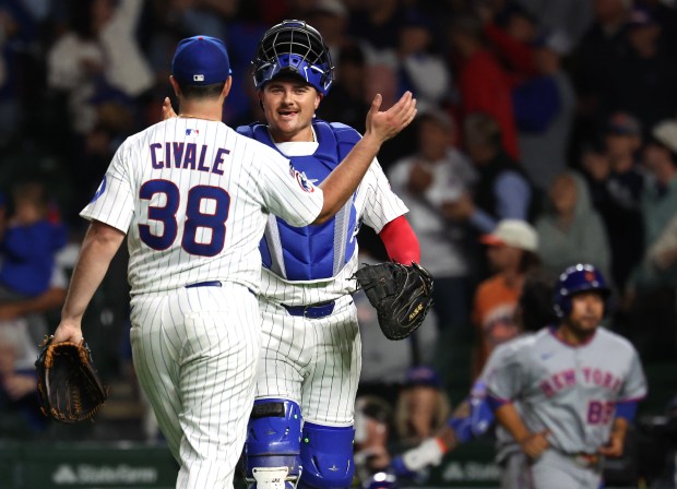 Chicago Cubs relief pitcher Aaron Civale (38) and catcher Reese McGuire celebrate after securing a victory by closing out the New York Mets in the ninth inning of a game at Wrigley Field in Chicago on Sept. 24, 2025. (Chris Sweda/Chicago Tribune)