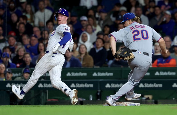 Chicago Cubs center fielder Pete Crow-Armstrong (4) looks back after being tagged out by New York Mets first baseman Pete Alonso (20) at first base in the seventh inning of a game at Wrigley Field in Chicago on Sept. 24, 2025. (Chris Sweda/Chicago Tribune)